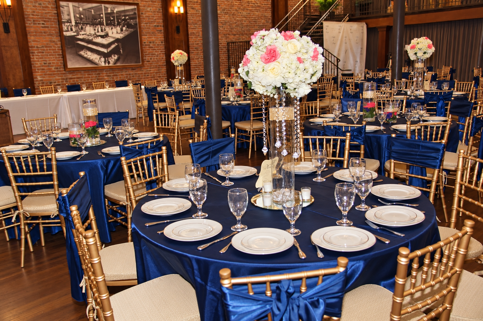Navy reception with white floral centerpieces